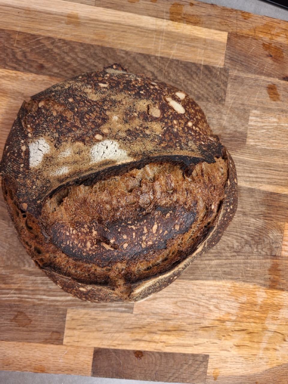 An overbaked, very dark sourdough loaf, top-down
