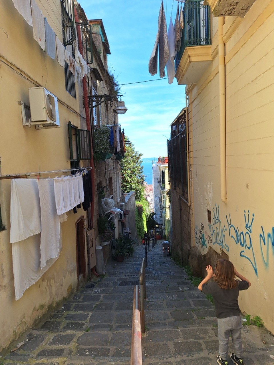 Narrow Naples alley with kids