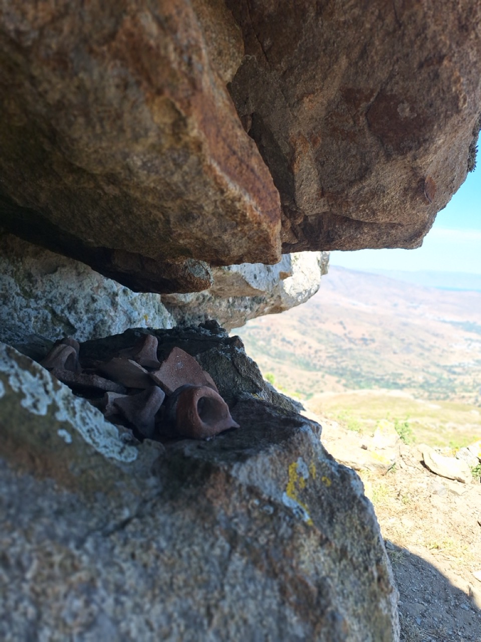Small clay offerings tucked into a niche in the rock